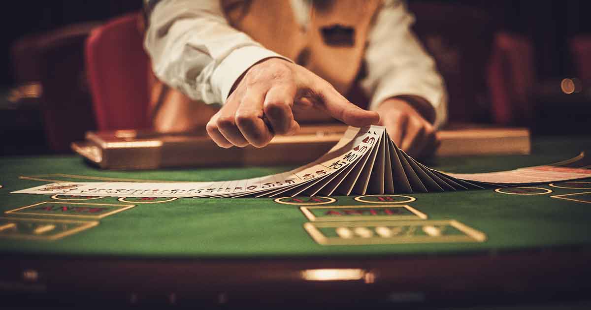 A casino dealer with a deck of cards