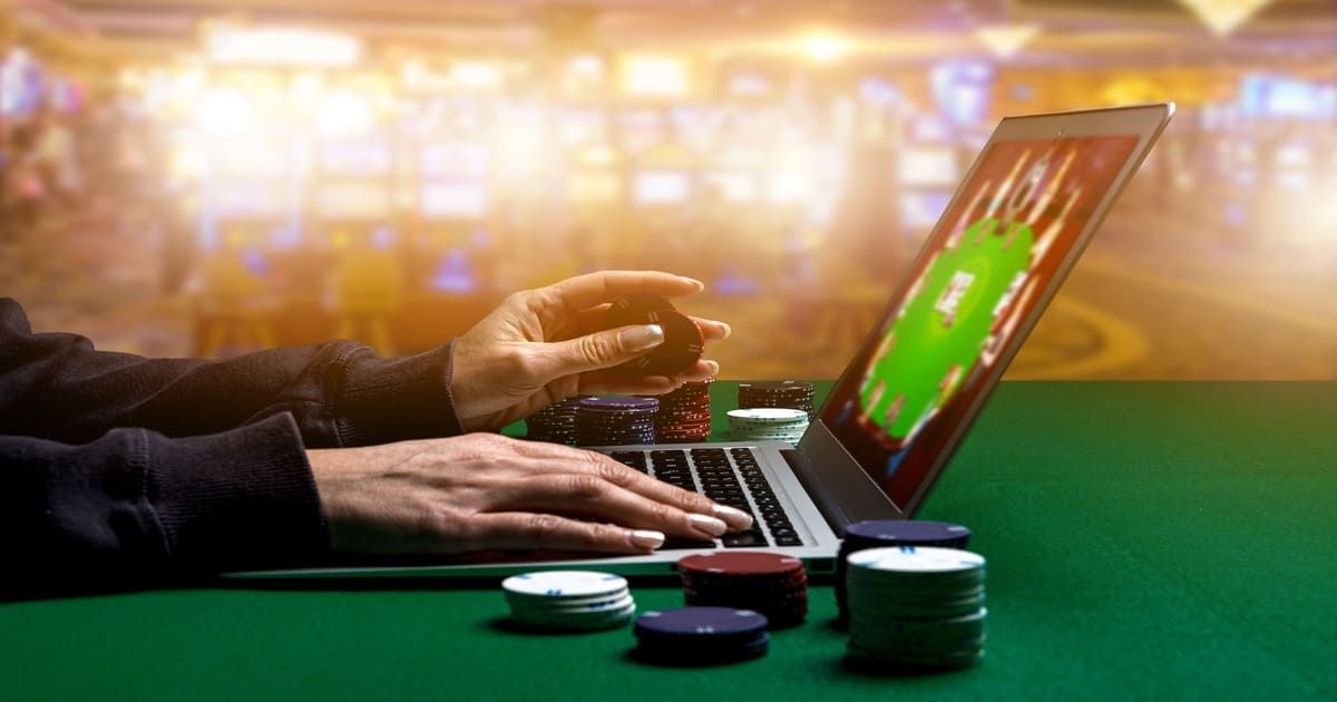 Man Playing Poker on a Laptop