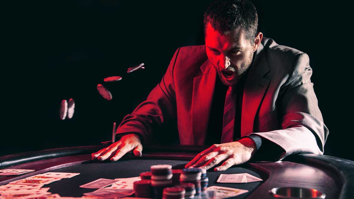 Man responds angrily at the poker table