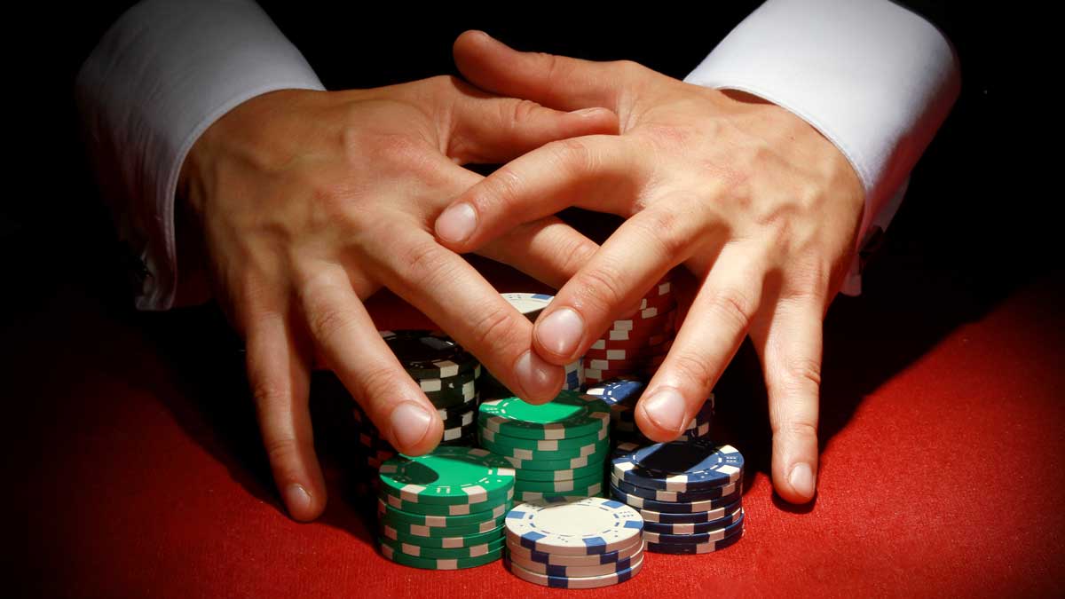 Man protecting a stack of poker chips