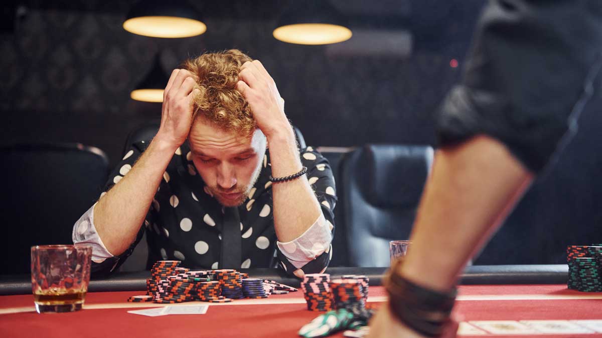 Man looking tired and frustrated at the poker table