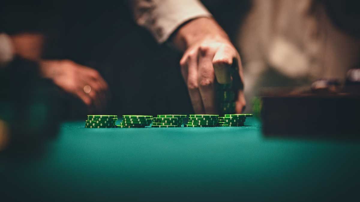 Man neatly stacking casino chips