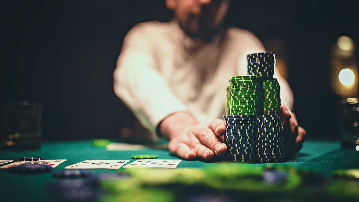 Man pushing a large stack of chips in poker